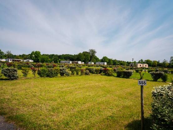 Grote kampeer-autoplaats op gras en zand